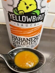Yellowbird Habanero Hot Sauce on a spoon