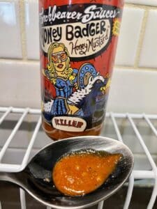 Torchbearer-Honey-Badger-Hot-Sauce-on-a-spoon