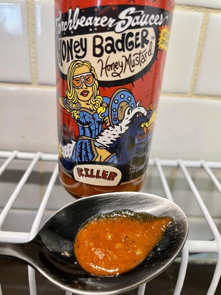 Torchbearer Honey Badger Hot Sauce on a spoon
