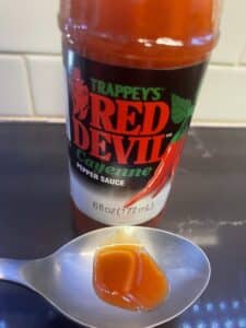 Trappey's Red Devil Cayenne Pepper Sauce on a spoon