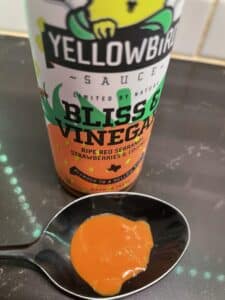 Yellowbird Bliss and Vinegar Hot Sauce on a spoon