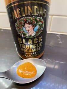 Melinda's Black Truffle Hot Sauce on a spoon